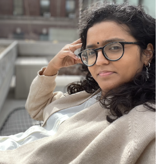 Deepti Sharma sitting on a roof