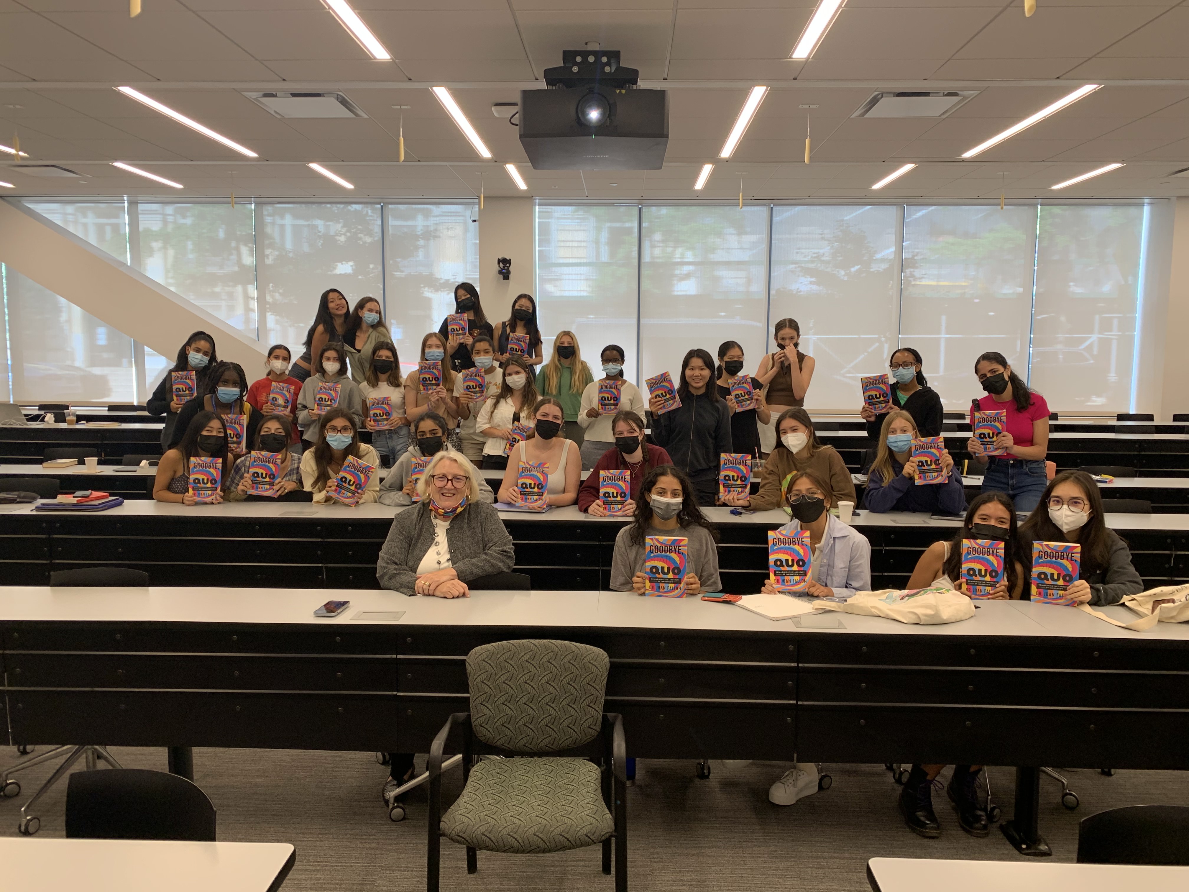 ASII 2022 cohort with Joan Fallon holding copies of her book, Goodbye Status Quo