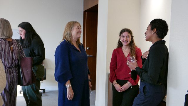 [Image description: Barnard President Laura Rosenbury talking with Startup Summit and Celebration of Entrepreneurship attendees.]