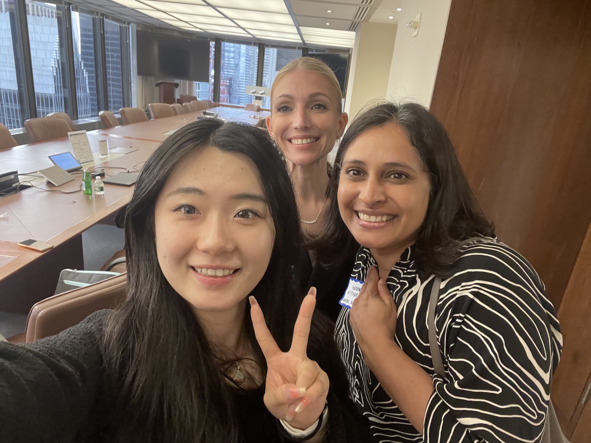 [Image description: Joyce Zhou '25, Jennifer Perusini '10, and Umbreen Bhatti '00 posing for a selfie after the 2023 Startup Summit.]