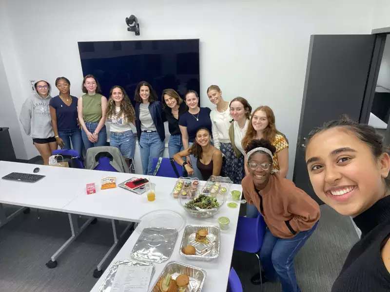 A group of smiling students with alum, Juliana Goldman