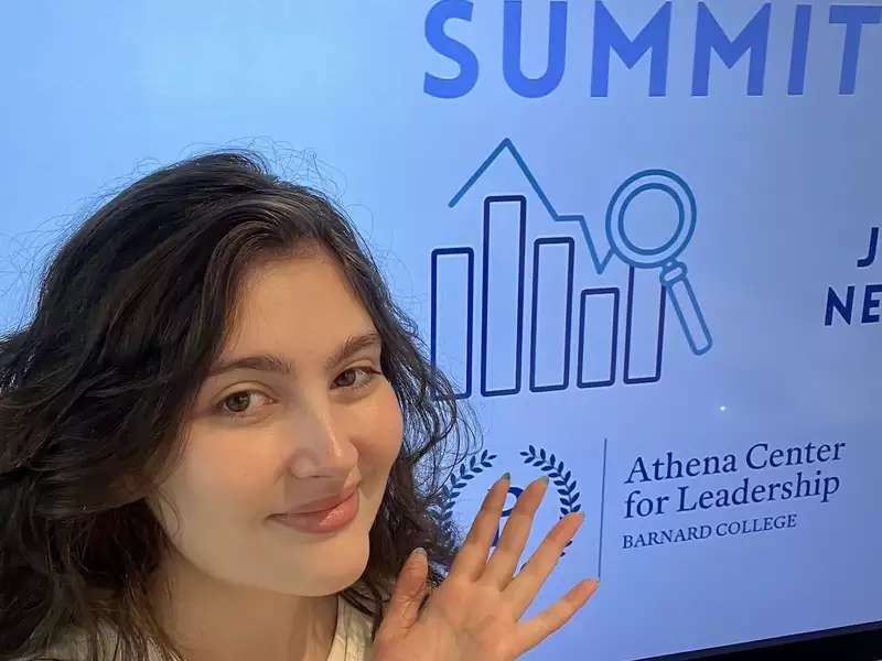 [Image description: Selfie of Lilly Montelle '27 in front of a screen that says "Barnard Startup Summit"]