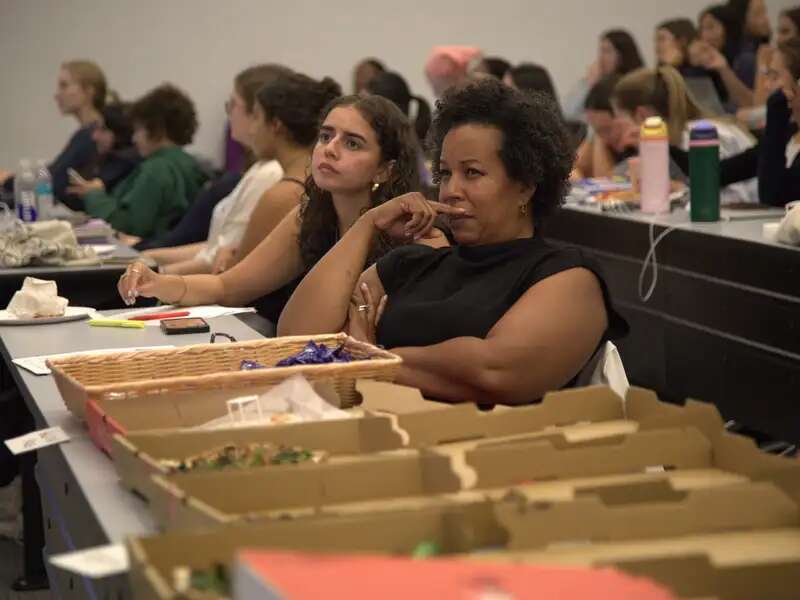 [Image description: Olivia Martinez '25 and Kimberly Peeler Allen watch the 2024 Presidential Debate]