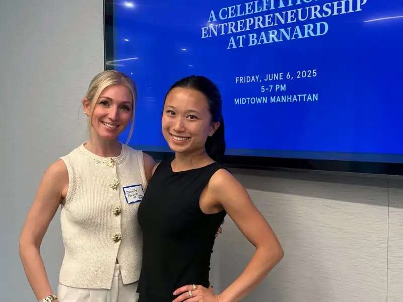 [Image description: Anika Wang '27 and Jennifer Perusini '10 standing arm in arm in front of a screen that reads "A Celebration of Entrepreneurship']
